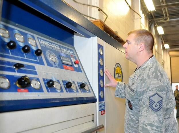 Master Sgt. Mike Kellebrew, a Unit Effectiveness Inspection fire emergency inspector, examine a Bauer Compressors air compression system at the Joint Base Charleston Fire Department April 13, 2016. These air compression systems fill the air tanks firefighters carry into situations that could possibly threaten their health. (U.S. Air Force Photo/Megan Munoz)