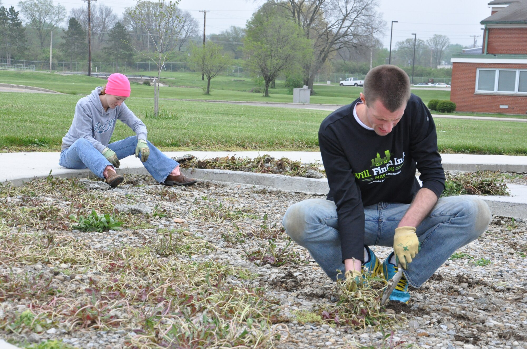 Wright-Patterson AFB Fallen Warrior Memorial Park work project volunteers, Master Sgt. Jamie Pope, Chief of Customer Service with the 445th Force Support Squadron and Ryan Helbach, an aerospace engineer with the Air Force Research Laboratory, remove weeds at the site prior to the installation of paving blocks around the memorial. With work now beginning on the final phase of the park’s construction, a dedication ceremony is planned for June. 