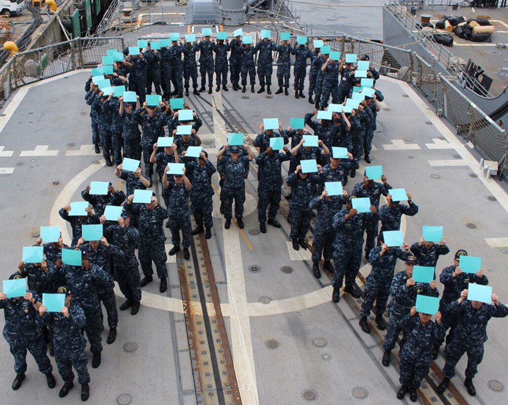 Sailors aboard the guided-missile cruiser USS Chancellorsville form a teal ribbon in recognition of  Sexual Assault Awareness and Prevention  Month, April 27, 2016. The teal ribbon signifies the Navy’s zero tolerance policy against sexual assault. 