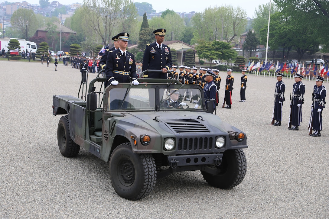 Gen. Curtis M. Scaparrotti, outgoing commander of United Nations Command, Combined Force Command and U.S. Forces Korea, and Gen. Vincent K. Brooks, incoming commander inspect the troops escorted by Capt. Michael Lee, commander of the United Nations Command Honor Guard, during a change of command ceremony on Knight Field, April 30.