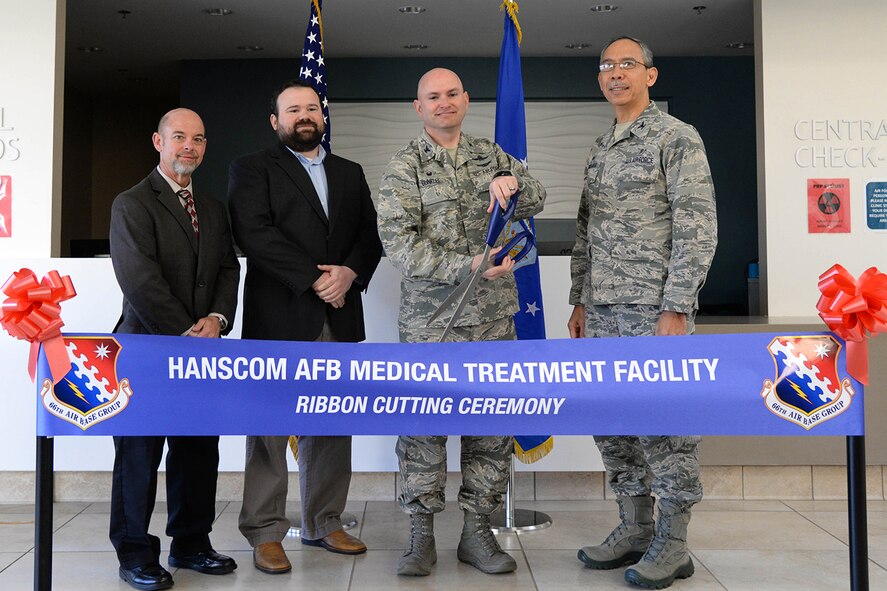 Mark Brightwell, left, U.S. Army Corps of Engineers, Doug McGrath, second from left, who served as the project manager, Col. David R. Dunklee and Col. Joel Almosara, prepare to cut a ribbon to mark the completion of a $12.5 million modernization project covering more than 3,700 square feet to Hanscom's Medical Treatment Facility. The modernization project began in February 2014. (U.S. Air Force photo by Linda LaBonte Britt) 