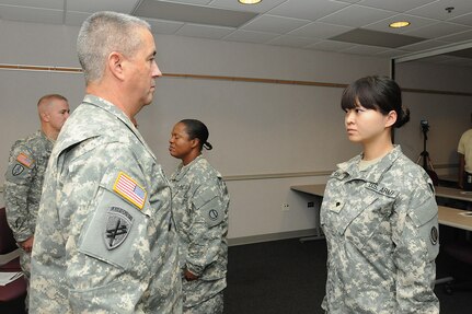 Spc. Jiaru Hyder, 85th Support Command, prepares to receive the rank of sergeant from Command Sgt. Maj. Kevin J. Greene, Command Sergeant Major, 85th Support Command, during a noncommissioned officer induction ceremony, Aug. 30, 2012. 2nd Lt. Jiaru Bryar, formerly Hyder, shared her story during Asian American and Pacific Islander Heritage Month 2015 discussing her journey as a child from Chang Chun city, in the Ji Lin province, located in northeastern People’s Republic of China to becoming an Army Reserve officer based in Chicago.
(U.S. Army photo by Mr. Anthony L. Taylor/Released)