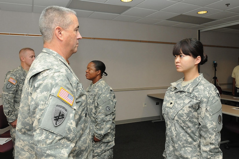 Spc. Jiaru Hyder, 85th Support Command, prepares to receive the rank of sergeant from Command Sgt. Maj. Kevin J. Greene, Command Sergeant Major, 85th Support Command, during a noncommissioned officer induction ceremony, Aug. 30, 2012. 2nd Lt. Jiaru Bryar, formerly Hyder, shared her story during Asian American and Pacific Islander Heritage Month 2015 discussing her journey as a child from Chang Chun city, in the Ji Lin province, located in northeastern People’s Republic of China to becoming an Army Reserve officer based in Chicago.
(U.S. Army photo by Mr. Anthony L. Taylor/Released)