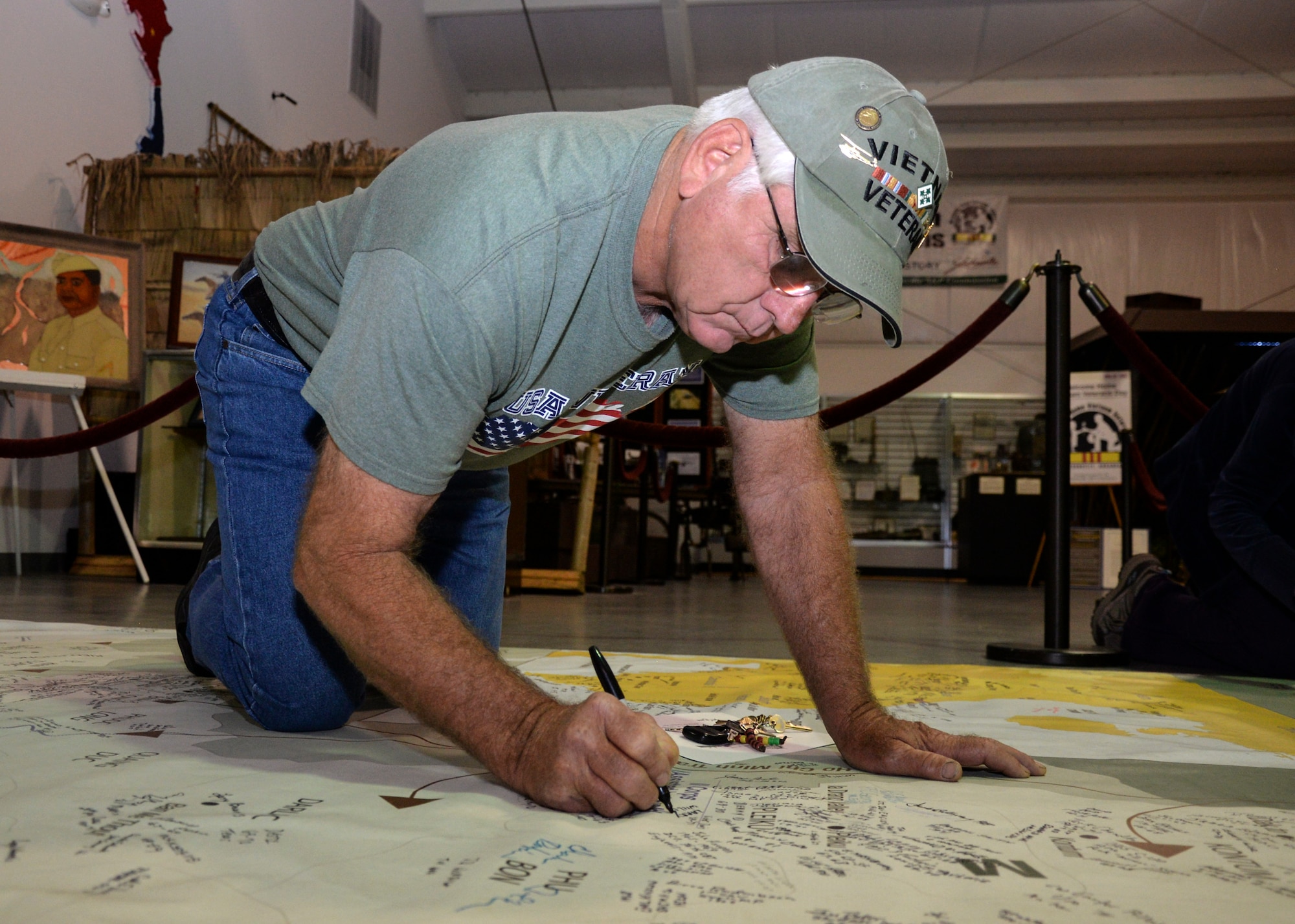 Larry Williams, a veteran assigned to the 4th Division during the Vietnam War, signs his name on a map representing the different areas U.S. forces occupied from 1955 to 1975 during the Welcome Home Vietnam Veterans ceremony April 30, 2016, at the Jacksonville Museum of Military History, Jacksonville, Ark. The map holds more than 1,000 names of Vietnam veterans and can be signed by veterans, family members of veterans. (U.S. Air Force photo by Staff Sgt. Jessica Condit)