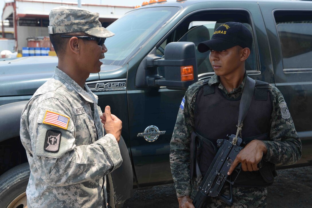 U.S. Army Sgt. Jason Nisperos, Joint Task Force-Bravo S-SAT preventative medicine NCO, from Soto Cano Air Base, Honduras, speaks with a soldier from the Honduran Naval Forces during a site survey at a sea port in Puerto Castilla, Honduras as part of a U.S. Southern Command Situational Assessment Team validation exercise, April 26, 2016. In the event of a natural disaster or humanitarian crisis this 11-member team is capable of responding within 18 hours to conduct assessments before significant military resources are committed to a humanitarian assistance or disaster response event. (U.S. Army photo by Frederick Hoyt/Released) 