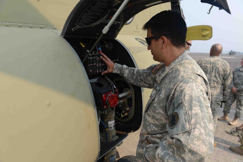 Chief Warrant Officer David Longoria, 1st battalion, 228th Aviation Regiment standardization pilot, assigned to Joint Task Force-Bravo, checks the fuel and burn rate on a CH-47 Chinook helicopter at Soto Cano, Airbase in Honduras, before a SOUTHCOM Situational Assessment Team deployment validation exercise, April 25, 2016. The 11-member S-SAT team traveled to Puerto Castilla, Honduras, where they participated in a portion of an Army SOUTH-hosted exercise called Fuerzas Aliadas Humanitarias, which is an annual event that tests the abilities of Caribbean and Central American nations to respond to a natural disaster or humanitarian crisis. (U.S. Army photo by Frederick Hoyt/Released) 