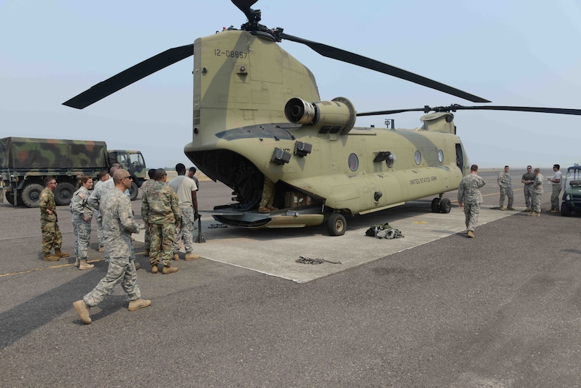 Army Forces Battalion, Headquarters Support Company Service Members, assigned to Joint Task Force-Bravo, at Soto Cano Air Base, Honduras, load a CH-47 Chinook helicopter, assigned to the 1st battalion, 228th Aviation Regiment, in preparation for a three-day deployment to validate their role as a SOUTHCOM Situational Assessment Team, April 25, 2016. The 11-member S-SAT team traveled to Puerto Castilla, Honduras, where they participated in a portion of an Army SOUTH-hosted exercise called Fuerzas Aliadas Humanitarias, which is an annual event that tests the abilities of Caribbean and Central American nations to respond to a natural disaster or humanitarian crisis. (U.S. Army photo by Frederick Hoyt/Released) 