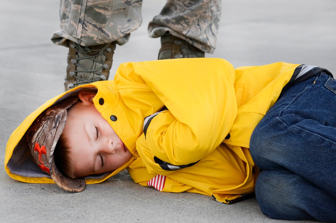 Camden Archbold, age 5, takes a break next to his father from the day’s festivities during the Arctic Thunder Special Needs and Family Day at Joint Base Elmendorf-Richardson, Alaska, July 29, 2016. Air Force photo by Airman 1st Class Valerie Monroy
