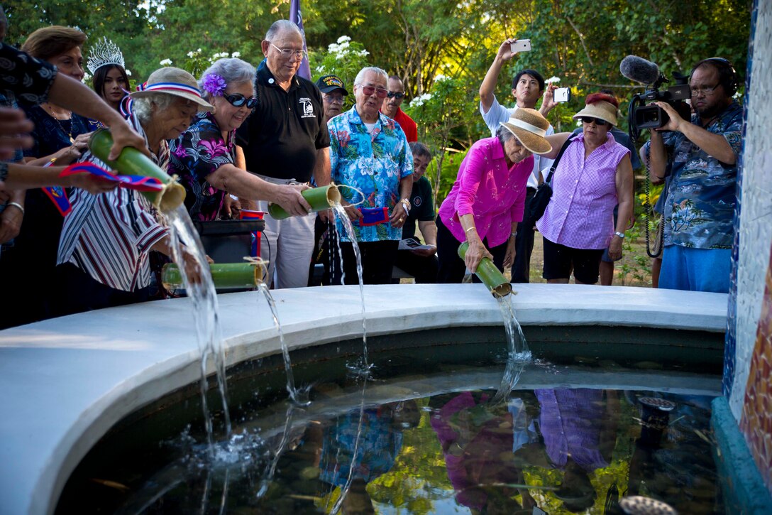 YONA, Guam (July 24, 2016) – Manenggon survivors pour water in to a memorial fountain during the Manenggon Memorial Foundation Memorial. Fellow U.S. Service members and the community of Guam gathered at Manenggon to honor the survivors and those that passed away during occupation in World War II. Manenggon was the site of a concentration camp during occupation. The citizens of Guam were forcefully marched down to Manenggon and many Chamorros did not make the journey.
