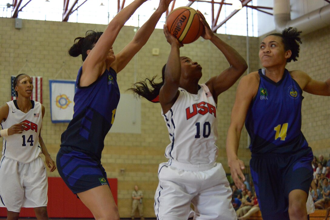 Spc. Donita Adams of the Maryland Army National Guard takes a shot despitedbeing double-teamed by Brazilian defenders during the final game of the CISM Women's Basketball Championship at Camp Pendleton, Calif., July 29, 2016.