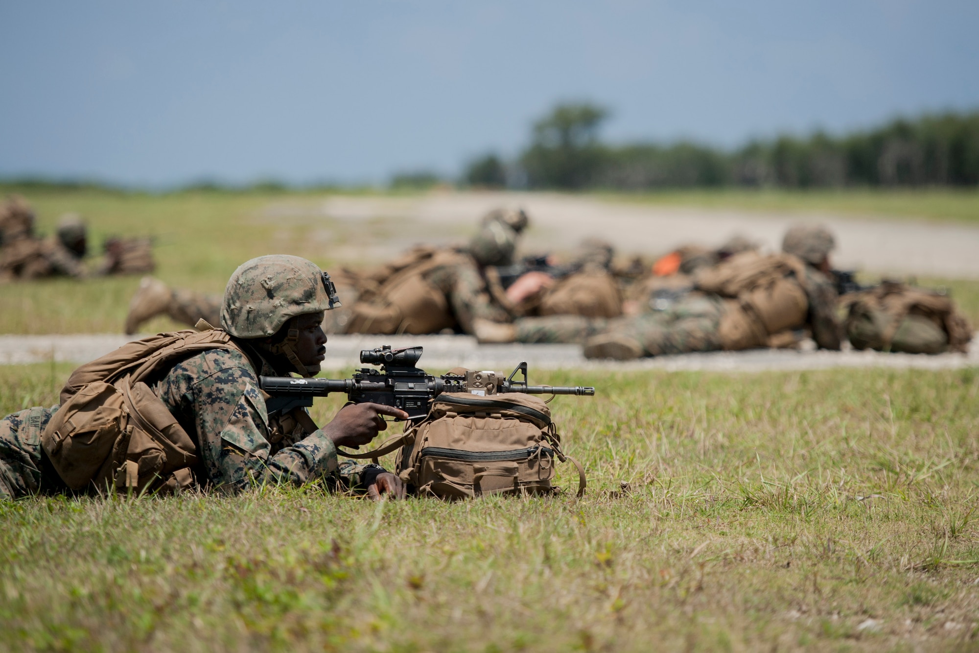 U.S. Marine Corps riflemen assigned to Golf Company, 2nd Battalion, 2nd Marine Regiment, Marine Corps Base Camp Lejeune, N.C., post a defensive perimeter during an airfield seizure exercise July 20, 2016, at Iejima airfield, Japan. Golf Company conducted their first long-range airfield seizure exercise with support from the Marine Medium Tiltrotor Squadron 265, Marine Corps Air Station Futenma, Japan and the U.S. Air Force 353rd Special Operations Group, Kadena Air Base, Japan. (U.S. Air Force Photo by Senior Airman Peter Reft) 