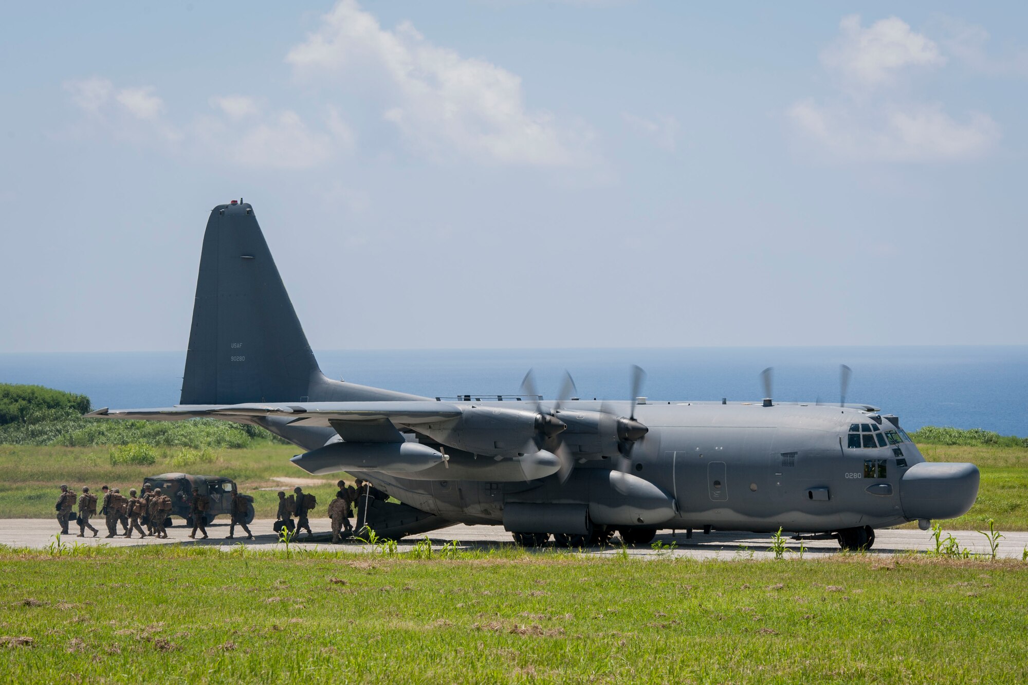 A U.S. Air Force MC-130H Combat Talon II assigned to the 17th Special Operations Squadron, Kadena Air Base, Japan, unloads U.S. Marines assigned to Golf Company, 2nd Battalion, 2nd Marine Regiment, Camp Lejeune, N.C., during a long-range airfield seizure July 20, 2016, at Iejima airfield, Japan. The Air Force and Marine Corps units combined forces in an exercise that helped build joint training relationships, enhancing interoperability of separate combat forces for contingency operations. (U.S. Air Force Photo by Senior Airman Peter Reft) 