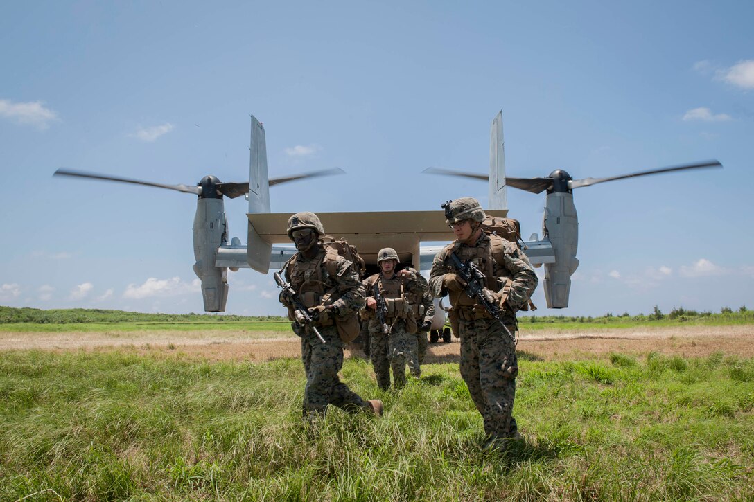 A U.S. Marine Corps MV-22 Osprey assigned to Marine Medium Tiltrotor Squadron 265, Marine Corps Air Station Futenma, Japan, drops off Marines assigned to Golf Company, 2nd Battalion, 2nd Marine Regiment, Marine Corps Base Camp Lejeune, N.C., during a long-range airfield seizure exercise July 20, 2016, at Iejima airfield, Japan. The Osprey can carry 24 combat troops, transport them with the speed and range of a fixed wing aircraft, and perform insertions or extractions with the maneuverability of rotor aircraft. (U.S. Air Force Photo by Senior Airman Peter Reft) 