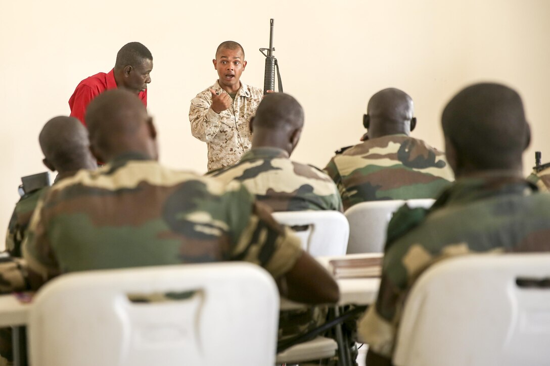 Staff Sgt. Jonathon St. Ann, a team chief with Special Purpose Marine-Air Ground Task Force Crisis Response-Africa, teaches a class about weapons handling to soldiers from the Compagnie Fusilier de Marin Commando in Thies, Senegal, July 20, 2016. Marines and the COFUMACO conducted a three-week training exercise that included advanced combat firing techniques, a machine gun range and a live-fire platoon attack range. (U.S. Marine Corps photo by 1st Lt. Eric Abrams /released)