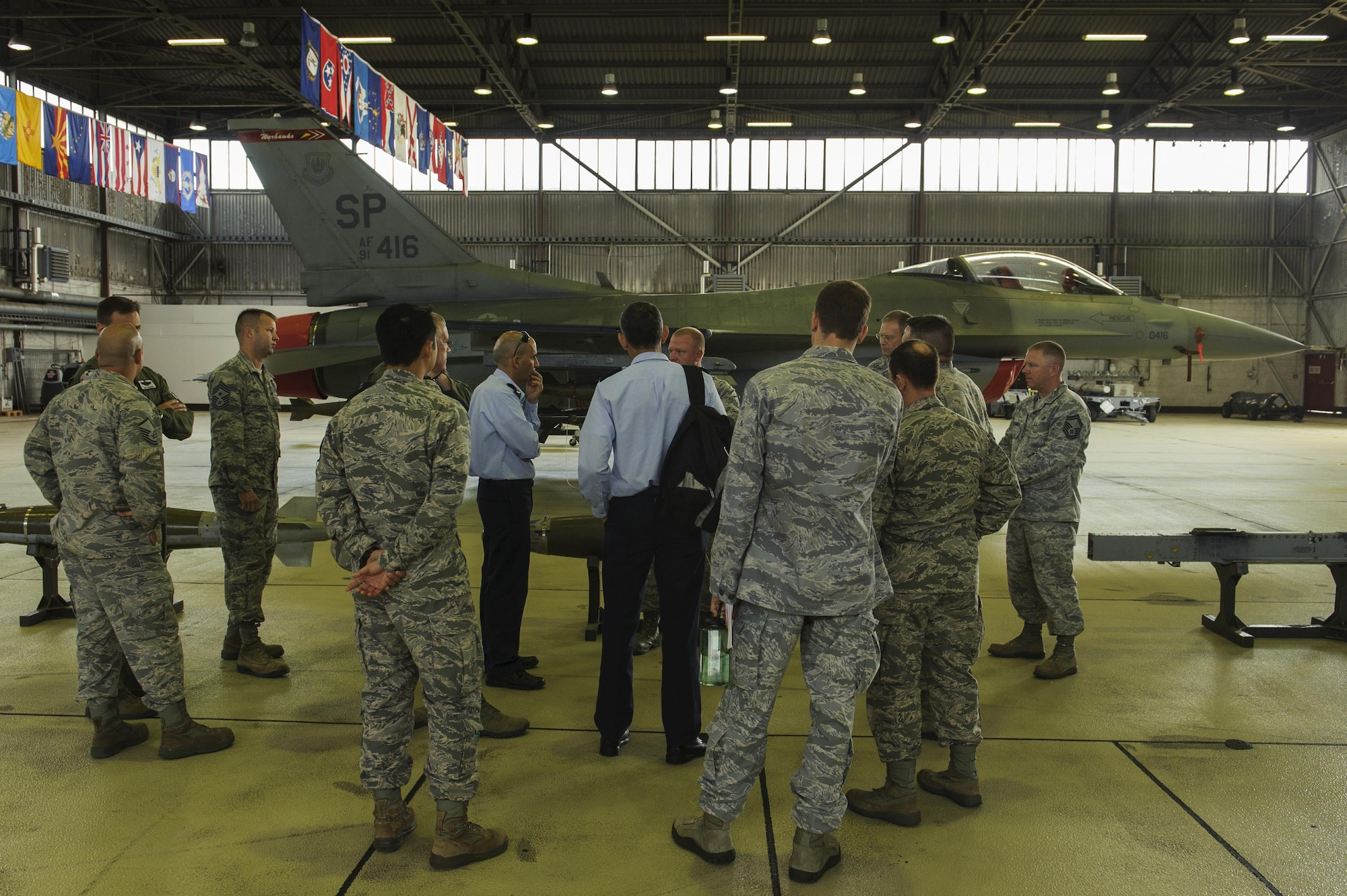 Brig. Gen. Tal Kelman, Israeli air force vice chief of staff, listens to U.S. Air Force Master Sgt. William Hawkins, 52nd Aircraft Maintenance Squadron production superintendent, talk about the capabilities of the 52nd AMXS supporting the F-16 Fighting Falcons to during his visit at Spangdahlem Air Base, Germany, July 27, 2016. Kelman's is visiting the base while attending the Air Senior National Representative forum, which works on enhancing IAF and USAF cooperation. (U.S. Air Force photo by Staff Sgt. Jonathan Snyder)
