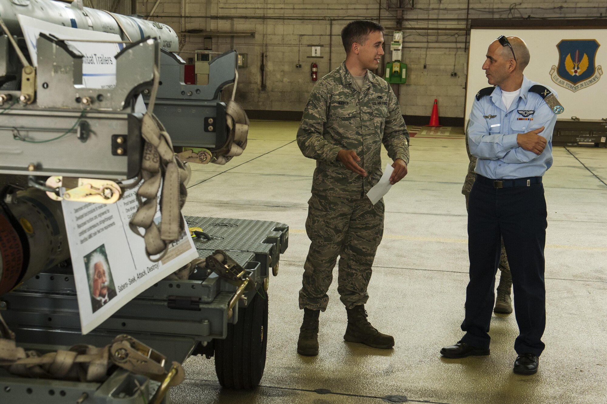 U.S. Air Force Senior Airman Alexander Kiefer, 52nd Maintenance Squadron precision guided munitions crew member, talks about the capabilities of the 52nd MXS supporting the F-16 Fighting Falcons to Brig. Gen. Tal Kelman, Israeli air force vice chief of staff, during his visit at Spangdahlem Air Base, Germany, July 27, 2016. Kelman's is visiting the base while attending the Air Senior National Representative forum, which works on enhancing IAF and USAF cooperation. (U.S. Air Force photo by Staff Sgt. Jonathan Snyder)