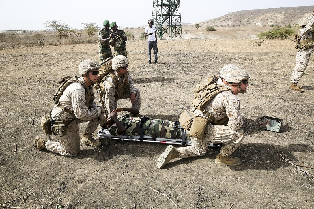 U.S Marines with Special Purpose Marine Air-Ground Task Force Crisis Response-Africa prepare to move a simulated casualty to a helicopter during a medivac rehearsal with the Compagnie Fusilier de Marin Commando in Thies, Senegal, July 21, 2016. This is the first time Marines and the COFUMACO have used a helicopter for medical assistance during training in Senegal. This new capability saves valuable time should an injury occur during live-fire ranges. (U.S. Marine Corps photo by 1st Lt. Eric Abrams /released)