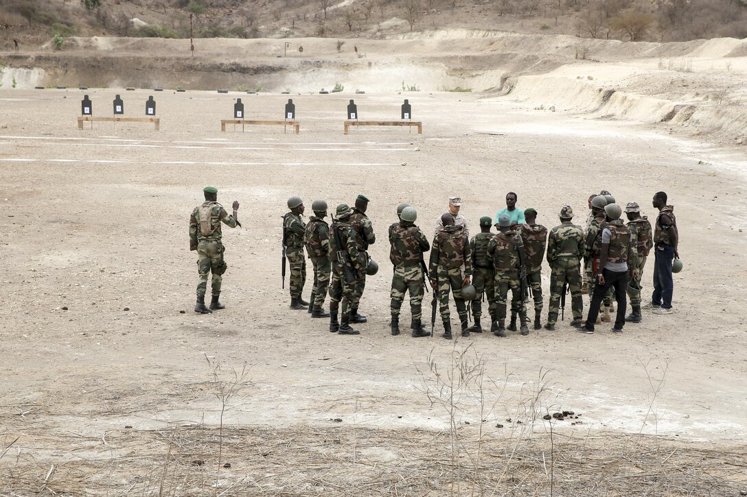 1st Lt. Justin Klein, a team leader with Special Purpose Marine-Air Ground Task Force Crisis Response-Africa, gives a range safety brief to soldiers from the Compagnie Fusilier de Marin Commando in Thies, Senegal, July 22, 2016. Marines and the COFUMACO conducted a three-week training exercise that included advanced combat firing techniques, a machine gun range and a live-fire platoon attack range. (U.S. Marine Corps photo by 1st Lt. Eric Abrams /released)