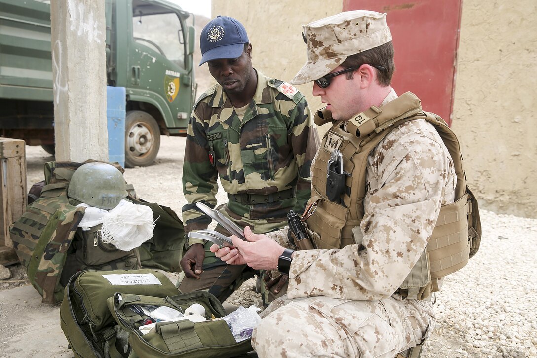 Lt. j.g. David Lane, a physician assistant with Special Purpose Marine Air-Ground Task Force Crisis Response-Africa, demonstrates appropriate use of medical equipment to medical personnel from the Compagnie Fusilier de Marin Commando in Thies, Senegal, July 22, 2016. Marines and the COFUMACO conducted a three-week training exercise that included advanced combat firing techniques, a machine gun range and a live-fire platoon attack range. (U.S. Marine Corps photo by 1st Lt. Eric Abrams/released)