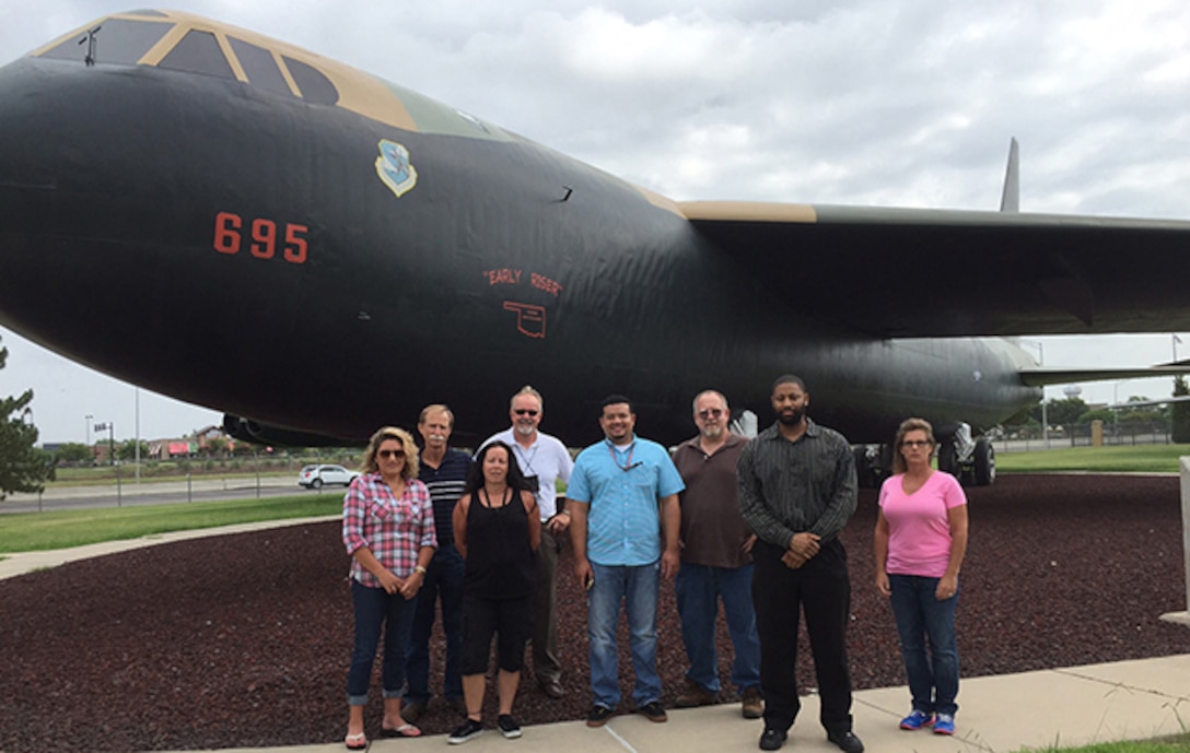 The Defense Logistics Agency Aviation at Oklahoma’s B-52 team stands next to the aircraft they support July 11, 2016 at the Oklahoma City Air Logistics Complex on Tinker Air Force Base, Oklahoma .