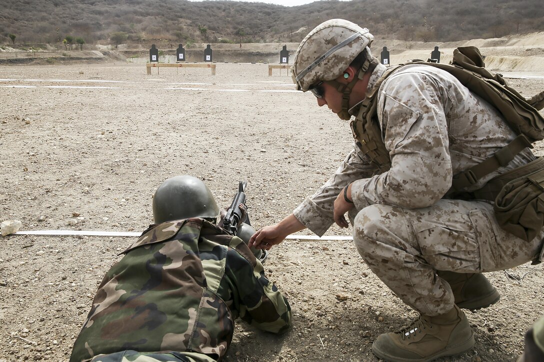 Sgt. Ryan Underwood, a rifleman with Special Purpose Marine Air-Ground Task Force Crisis Response-Africa, checks a weapon during a live-fire training exercise with the Compagnie Fusilier de Marin Commando in Thies, Senegal, July 22, 2016. Marines and the COFUMACO conducted a three-week training exercise that included advanced combat firing techniques, a machine gun range and a live-fire platoon attack range. (U.S. Marine Corps photo by 1st Lt. Eric Abrams /released)