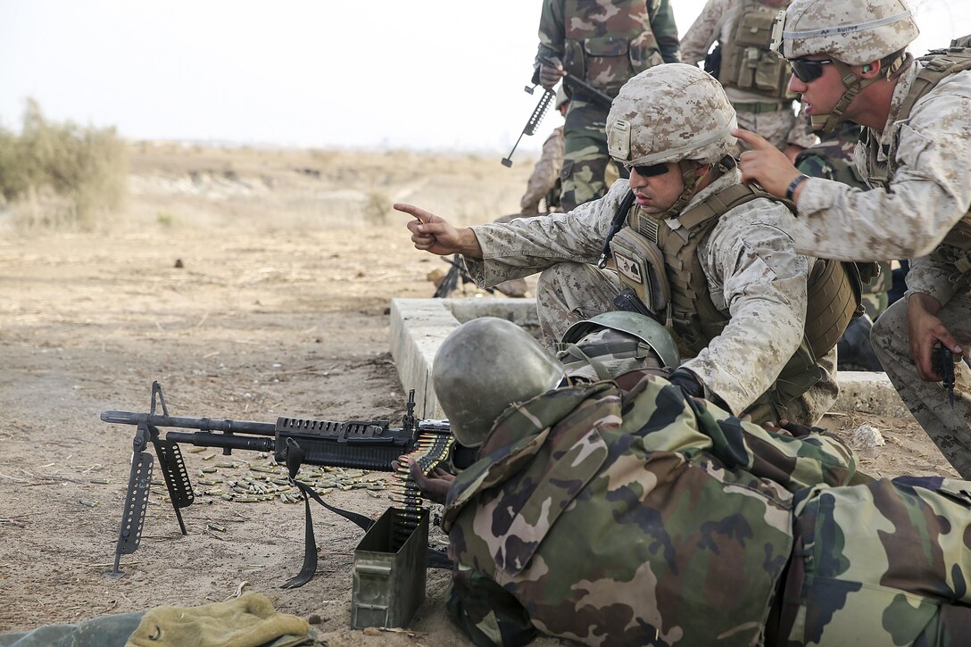 Sgt. Angelo Agudelo and Sgt Ryan Underwood, riflemen with Special Purpose Marine Air-Ground Task Force Crisis Response-Africa, give instruction during a machine gun range with the Compagnie Fusilier de Marin Commando in Thies, Senegal, July 22, 2016. Marines and the COFUMACO conducted a three-week training exercise that included advanced combat firing techniques, a machine gun range and a live-fire platoon attack range. (U.S. Marine Corps photo by 1st Lt. Eric Abrams /released)
