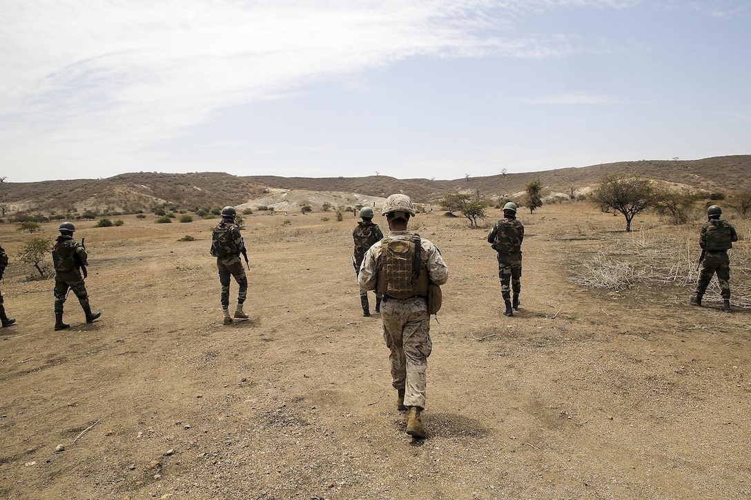 Sgt. Angelo Agudelo, a rifleman with Special Purpose Marine Air-Ground Task Force Crisis Response-Africa, follows a squad during the platoon attack range with the Compagnie Fusilier de Marin Commando in Thies, Senegal, July 22, 2016. Marines and the COFUMACO conducted a three-week training exercise that included advanced combat firing techniques, a machine gun range and a live-fire platoon attack range. (U.S. Marine Corps photo by 1st Lt. Eric Abrams /released)