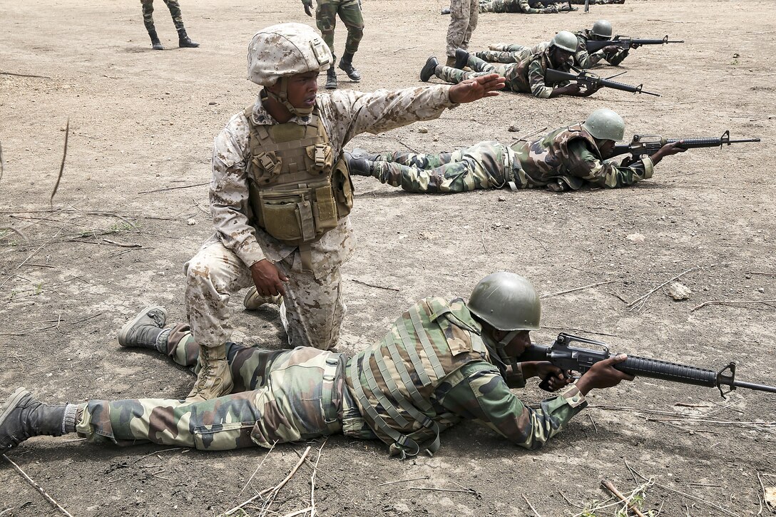 Staff Sgt. Jonathon St. Ann, a team chief with Special Purpose Marine-Air Ground Task Force Crisis Response-Africa, gives direction during a during the platoon attack range with the Compagnie Fusilier de Marin Commando in Thies, Senegal, July 22, 2016. Marines and the COFUMACO conducted a three-week training exercise that included advanced combat firing techniques, a machine gun range and a live-fire platoon attack range. (U.S. Marine Corps photo by 1st Lt. Eric Abrams /released)