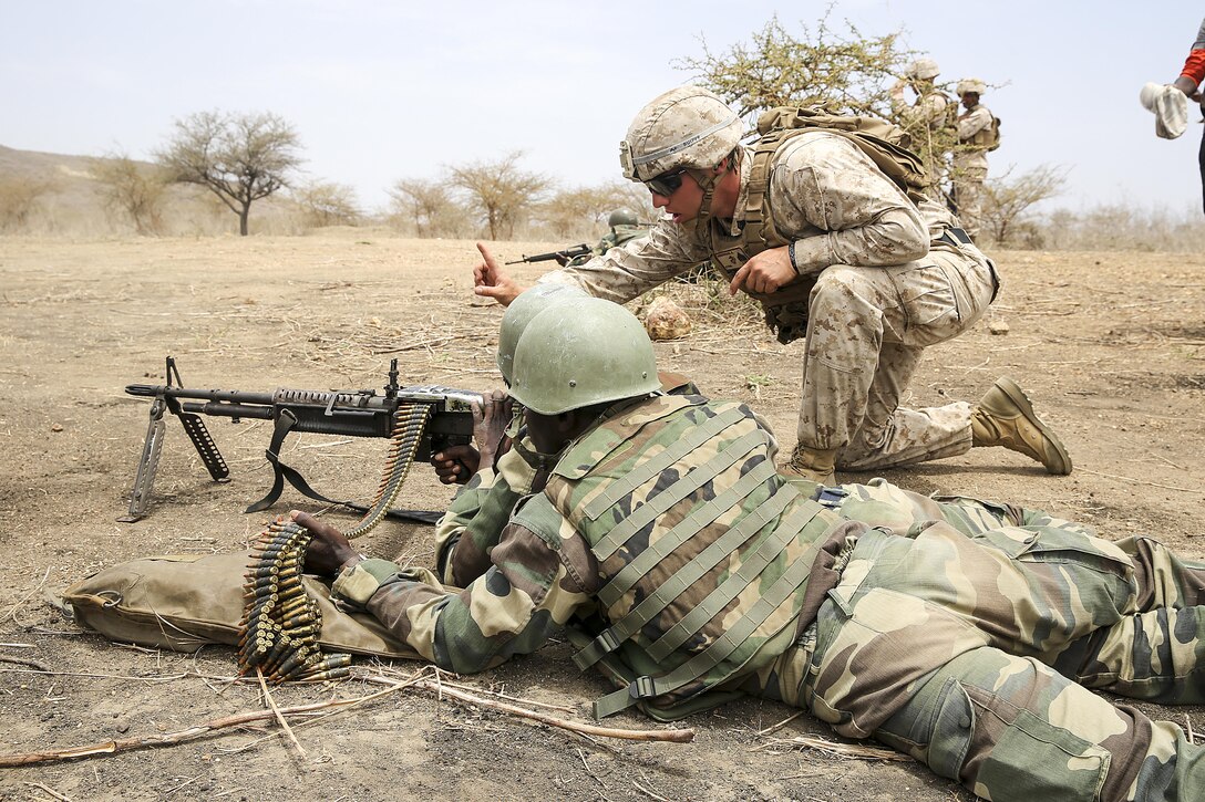 Sgt. Ryan Underwood, a rifleman with Special Purpose Marine Air-Ground Task Force Crisis Response-Africa, gives instruction during the platoon attack range with the Compagnie Fusilier de Marin Commando in Thies, Senegal, July 22, 2016. Marines and the COFUMACO conducted a three-week training exercise that included advanced combat firing techniques, a machine gun range and a live-fire platoon attack range. (U.S. Marine Corps photo by 1st Lt. Eric Abrams /released)