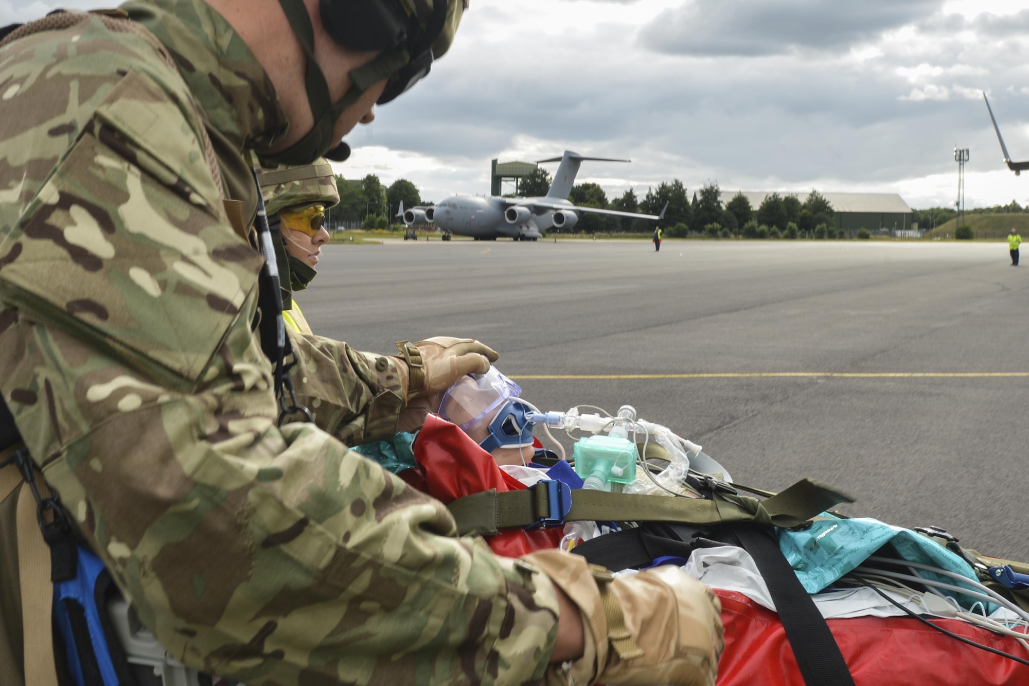 Joint-force medical personnel attend to a simulated casualty during exercise Combat Joint Atlantic Serpent at Royal Air Force Brize Norton, England, July, 25. U.K. and U.S. forces worked together during CJAS to get a better understanding of each military’s methods of aeromedical transportation and evacuation. (U.S. Air Force photo /Senior Airman Nigel Sandridge)
