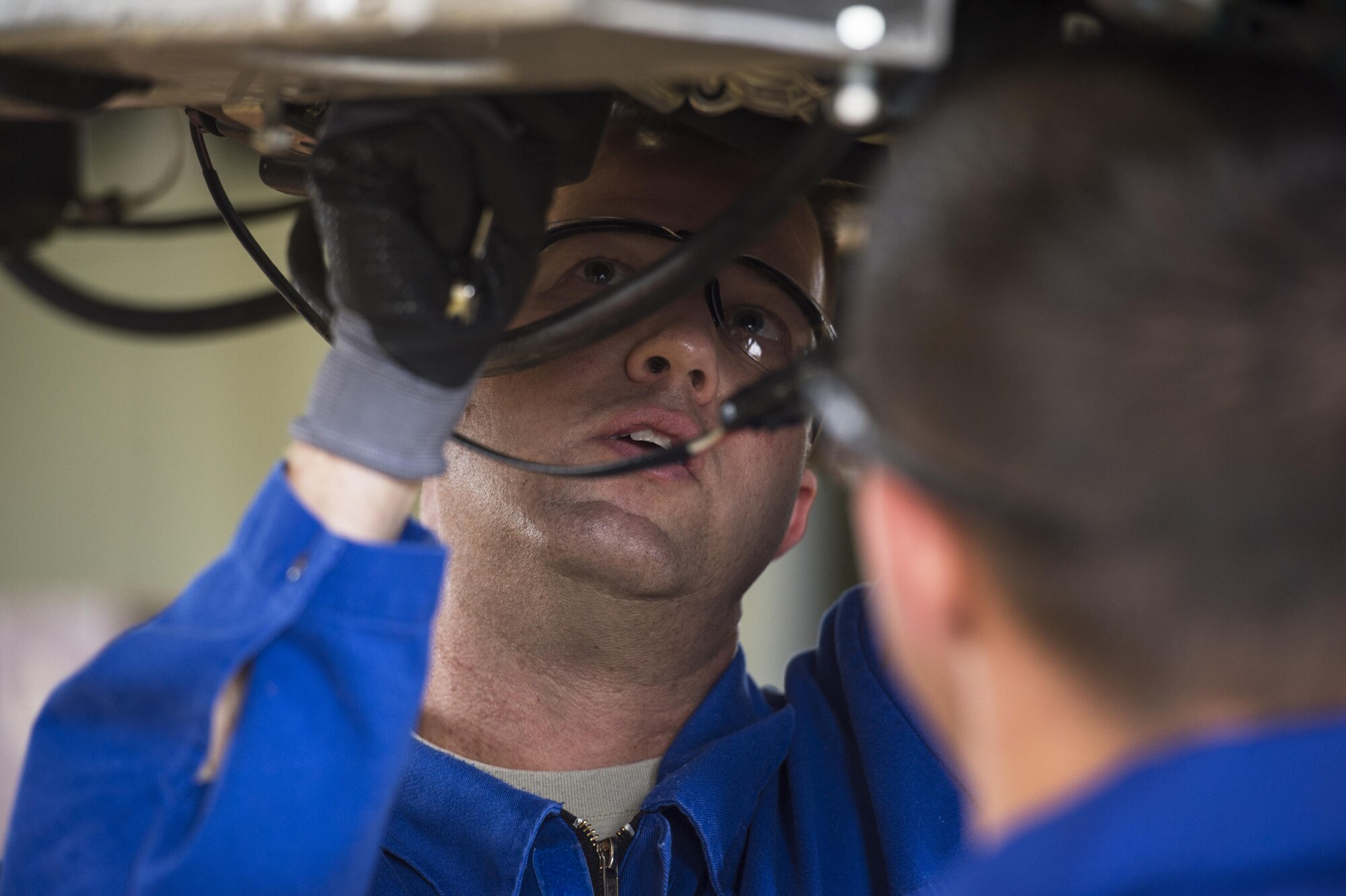 U.S. Air Force Chief Master Sgt. Edwin Ludwigsen, 52nd Fighter Wing command chief, center, assists Senior Airman Casey Choiniere, 52nd Logistic Readiness Squadron vehicle maintenance technician, fix a deicing truck at Spangdahlem Air Base, Germany, July 28, 2016. The 52nd FW commander and command chief had the opportunity to work alongside and learn firsthand what 52nd LRS vehicle management special purpose shop Airmen do. (U.S. Air Force photo by Staff Sgt. Jonathan Snyder/Released)
