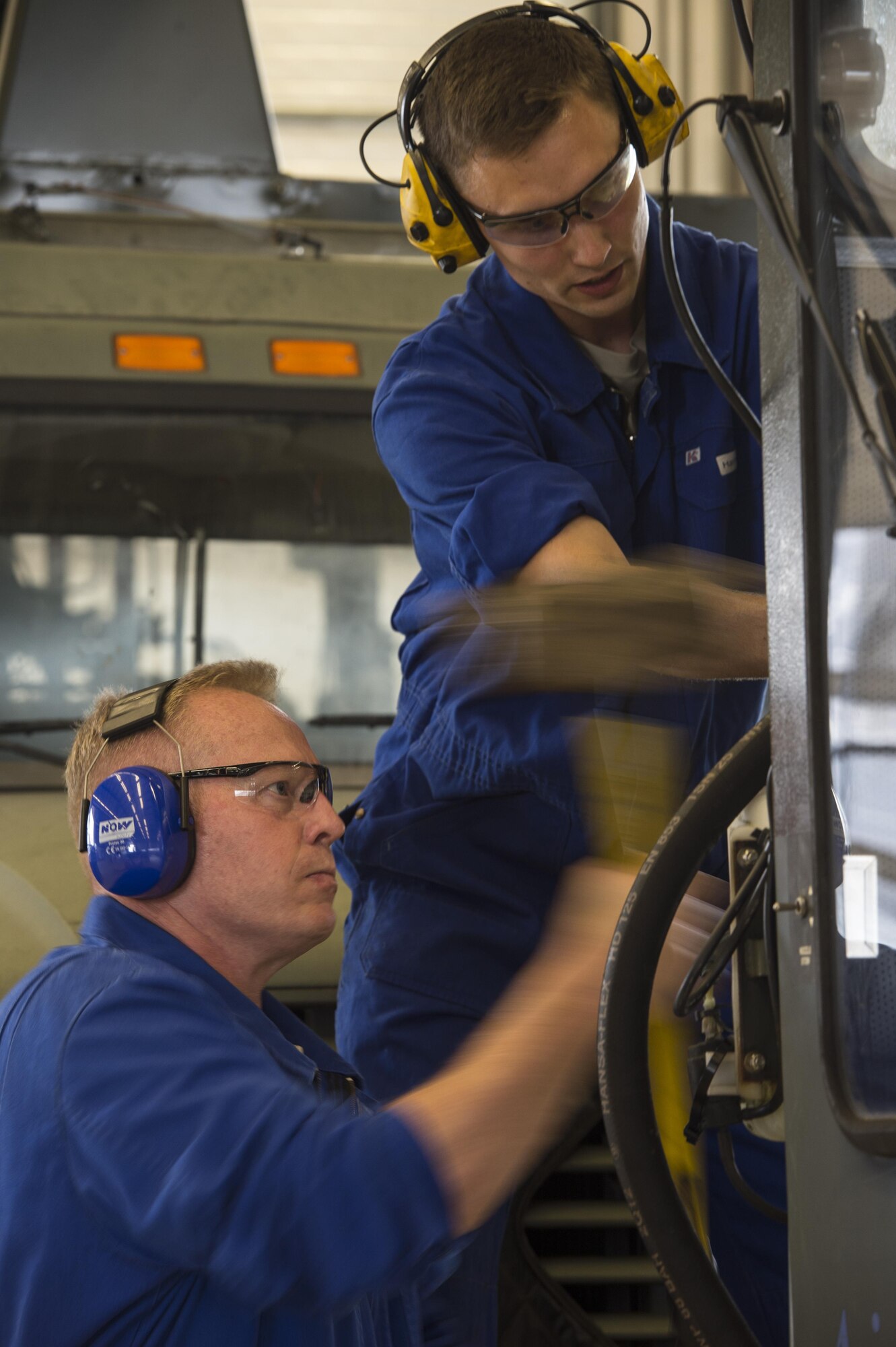 U.S. Air Force Col. Joseph McFall, 52nd Fighter Wing commander, left, assists Senior Airman Andrew Harmel, 52nd Logistic Readiness Squadron vehicle maintenance technician, fix a deicing truck at Spangdahlem Air Base, Germany, July 28, 2016. McFall and Chief Master Sgt. Edwin Ludwigsen, 52nd Fighter Wing command chief, had the opportunity to work alongside and learn firsthand what 52nd LRS vehicle management special purpose shop Airmen do. (U.S. Air Force photo by Staff Sgt. Jonathan Snyder/Released)