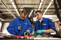 U.S. Air Force Chief Master Sgt. Edwin Ludwigsen, 52nd Fighter Wing command chief, left, assists Senior Airman Casey Choiniere, 52nd Logistic Readiness Squadron vehicle maintenance technician, fix a deicing truck at Spangdahlem Air Base, Germany, July 28, 2016. The 52nd FW commander and command chief had the opportunity to work alongside and learn firsthand what 52nd LRS, vehicle management special purpose shop Airmen do. (U.S. Air Force photo by Staff Sgt. Jonathan Snyder/Released)