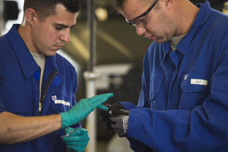 U.S. Air Force Chief Master Sgt. Edwin Ludwigsen, 52nd Fighter Wing command chief, right, assists Senior Airman Casey Choiniere, 52nd Logistic Readiness Squadron vehicle maintenance technician, fix a deicing truck at Spangdahlem Air Base, Germany, July 28, 2016. The 52nd FW commander and command chief had the opportunity to work alongside and learn firsthand what 52nd LRS vehicle management special purpose shop Airmen do. (U.S. Air Force photo by Staff Sgt. Jonathan Snyder/Released)