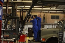 U.S. Air Force Col. Joseph McFall, 52nd Fighter Wing commander, right, assists Senior Airman Andrew Harmel, 52nd Logistic Readiness Squadron vehicle maintenance technician, fix a deicing truck at Spangdahlem Air Base, Germany, July 28, 2016. The 52nd FW commander and command chief had the opportunity to work alongside and learn firsthand what 52nd LRS, vehicle management special purpose shop Airmen do. (U.S. Air Force photo by Staff Sgt. Jonathan Snyder/Released)
