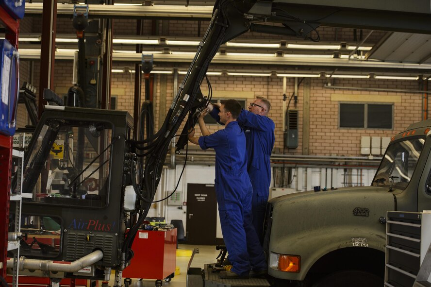 U.S. Air Force Col. Joseph McFall, 52nd Fighter Wing commander, right, assists Senior Airman Andrew Harmel, 52nd Logistic Readiness Squadron vehicle maintenance technician, fix a deicing truck at Spangdahlem Air Base, Germany, July 28, 2016. The 52nd FW commander and command chief had the opportunity to work alongside and learn firsthand what 52nd LRS, vehicle management special purpose shop Airmen do. (U.S. Air Force photo by Staff Sgt. Jonathan Snyder/Released)
