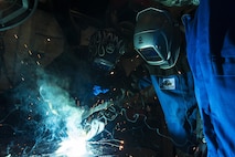 U.S. Air Force Col. Joseph McFall, 52nd Fighter Wing commander, center left, learns how to weld in the vehicle management special purpose shop at Spangdahlem Air Base, Germany, July 28, 2016. The 52nd FW commander and command chief had the opportunity to work alongside and learn firsthand what 52nd LRS vehicle management special purpose shop Airmen do. (U.S. Air Force photo
by Staff Sgt. Jonathan Snyder/Released)