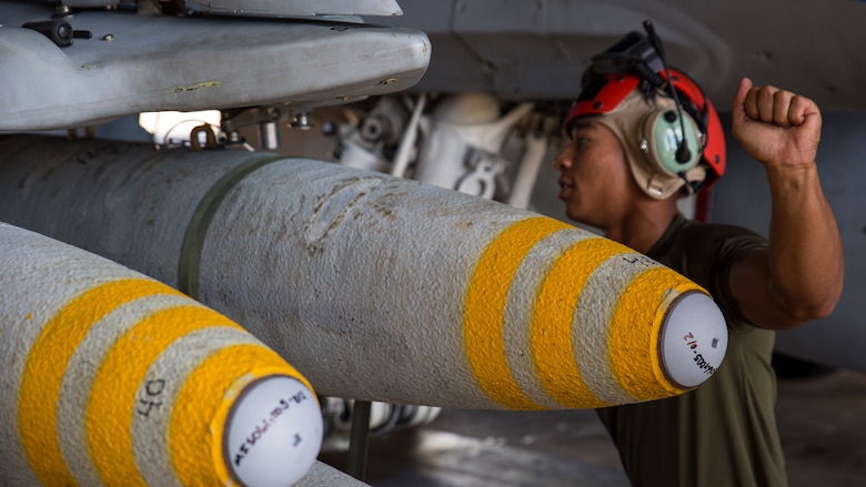 Cpl. Javon Franklin, an aviation ordnance technician with Marine Fighter Attack Squadron 122, assists in loading high explosive ordnance on an F/A-18C Hornet during exercise Southern Frontier at Royal Australian Air Force Base Tindal, Australia, July 28, 2016. Southern Frontier is three weeks of unit level training helping the squadron gain experience and qualifications in low altitude, air-ground, high explosive ordnance delivery at the unit level. VMFA-122 is home based out of Marine Corps Air Station Beaufort, South Carolina and are currently assigned to MAG-12 at MCAS Iwakuni under the Unit Deployment Program.