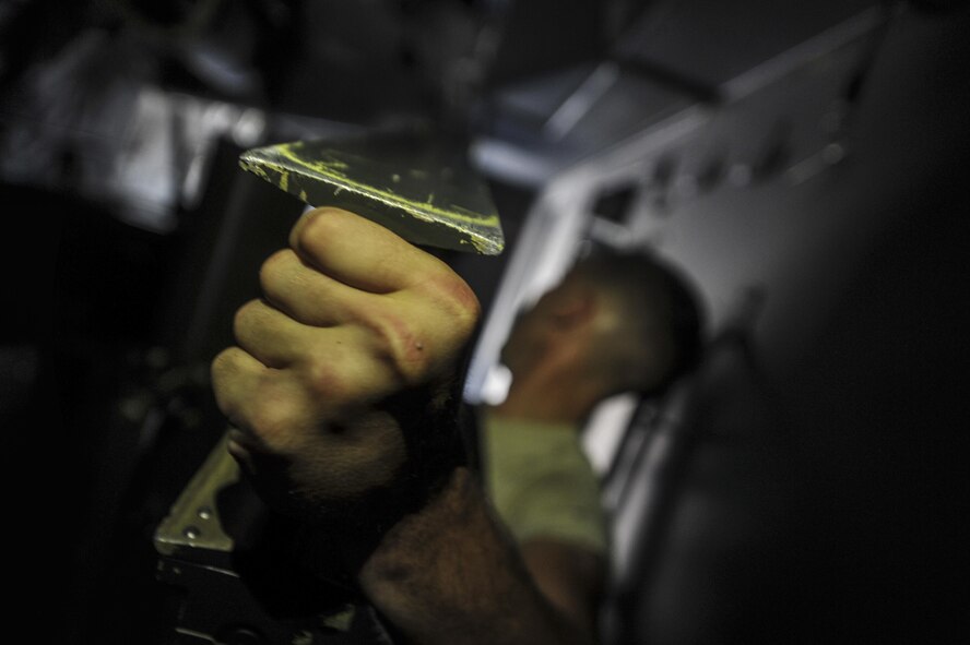 Senior Airman Seth Carnahan, a weapons load crew member with the 4th Aircraft Maintenance Unit, carries an Ammo Storage Handling System lifting fixture to an AC-130U Spooky gunship at Hurlburt Field, Fla., July 20, 2016. The ASHS feeds ammunition to the 25mm cannon that is located inside the aircraft's cargo hold; it is capable of carrying 3,000 rounds. (U.S. Air Force photo by Airman Dennis Spain)
