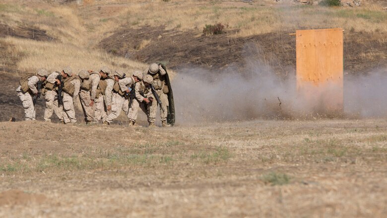 Marines from 1st Battalion, 5th Marine Regiment, 1st Marine Division shield themselves behind a blast blanket as they detonate a water charge at Camp Pendleton, California, July 26, 2016. Marines from the battalion conducted a live-fire exercise to create a realistic training environment and familiarize them with improvised breaching charges.