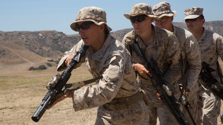 Marines from 1st Battalion, 5th Marine Regiment, 1st Marine Division rush through a door after detonating a breaching charge at Camp Pendleton, California, July 26, 2016. The Marines conducted live-fire training allowing them the opportunity to work with breaching charges and familiarizing them with the capabilities of each charge. 