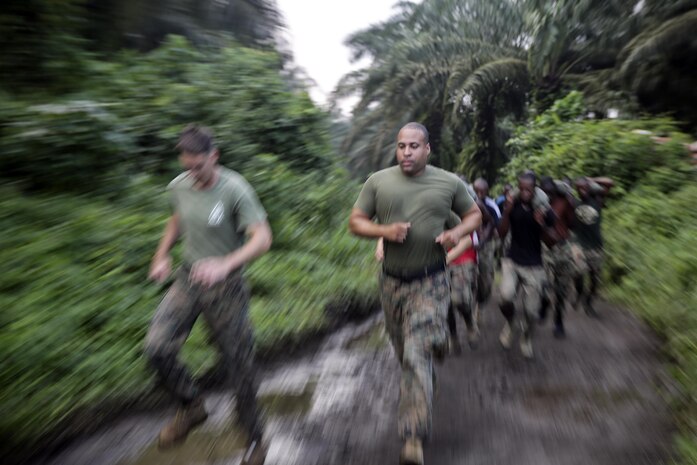 Sgt. Edgar Rodriguez, a rifleman with Special Purpose Marine Air-Ground Task Force Crisis Response-Africa, runs with Cameroonian soldiers with Forces Fusiliers Marins et Palmeurs de Combat during a physical training exercise in Limbé, Cameroon, June 29, 2016.  Marines share tactics, techniques and skills with the FORFUMAPCO soldiers to combat the illicit trafficking in Cameroon.  (U.S. Marine Corps photo by Cpl. Alexander Mitchell/released)