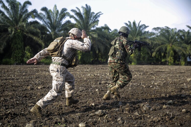 Cpl. Jeremy Osteen, a squad leader with Special Purpose Marine Air-Ground Task Force Crisis Response-Africa, runs behind a Cameroonian soldier with Forces Fusiliers Marins et Palmeurs de Combat as he conducts a buddy rush on the range in Limbé, Cameroon, July 1, 2016.  Marines share tactics, techniques and skills with the FORFUMAPCO soldiers to combat the illicit trafficking in Cameroon.  (U.S. Marine Corps photo by Cpl. Alexander Mitchell/released)
