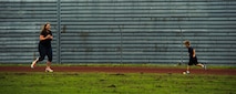 Jennifer Hartzog, cancer survivor, runs with her son Sam Hartzog during Relay For Life at Spangdahlem Air Base, Germany, July 29, 2016. Airmen and their families raised more than $12,000 for the American Cancer Society during this 24-hour relay event. (U.S. Air Force photo by Staff Sgt. Jonathan Snyder/Released)