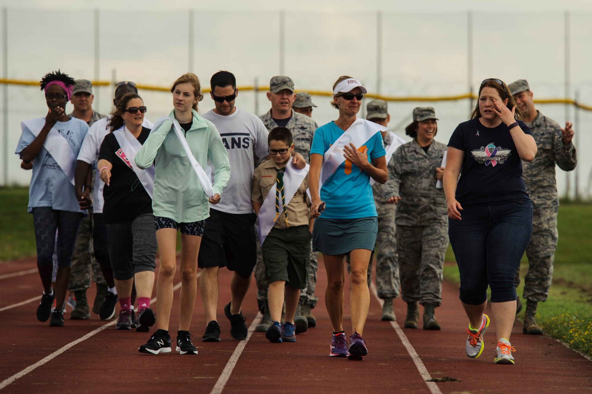 Airmen and family members walk during Relay For Life at Spangdahlem Air Base, Germany, July 29, 2016. Airmen and family members walk to honor cancer survivors and caregivers during the opening ceremony of this 24-hour relay event. (U.S. Air Force photo by Staff Sgt. Jonathan Snyder/Released)