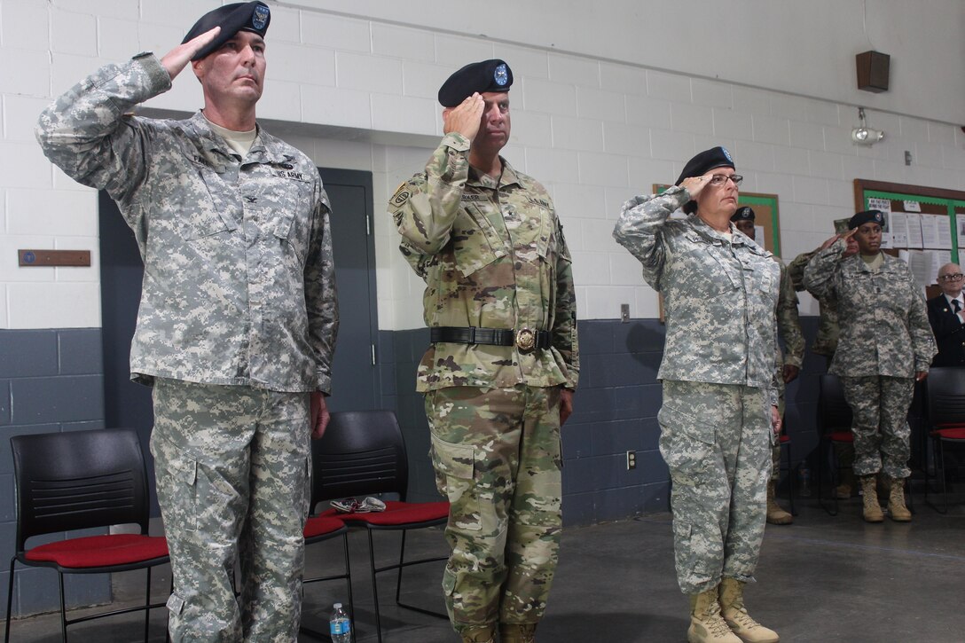 Army Reserve Soldiers, (left to right) Col Paul H. Fall, outgoing commander, 38th Regional Support Group, Brig. Gen. Vincent B. Barker, commanding general of the 310th Sustainment Command (Expeditionary), and incoming commander, 38th Regional Support Group Col. Ann M. Pellien present arms during the change of command ceremony conducted July 16, at the United States Army Reserve Center, Cross Lanes, West Va.  (Official U.S. Army Photo by Sgt. Sofenial Ford, 38th Regional Support Group)