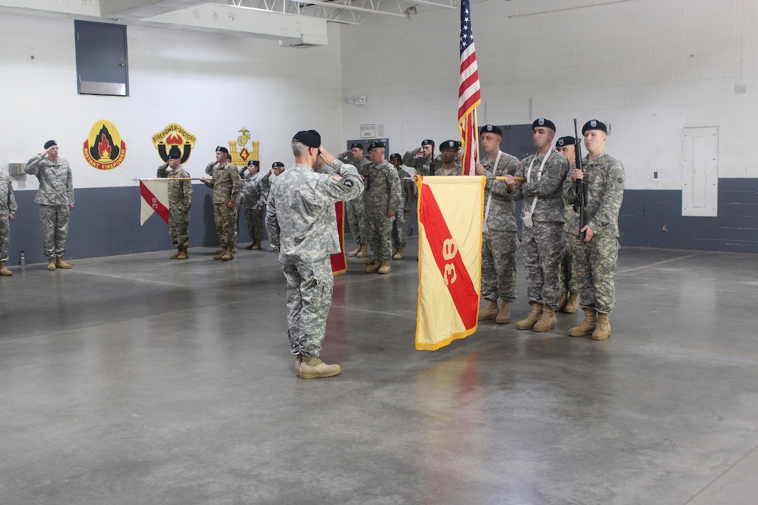 The outgoing commander, Col. Paul H. Fall hands over command to Col Ann. M. Pellien during the Army Reserve’s 38th Regional Support Group change of command ceremony.  The change of command ceremony was conducted July 16, at the United States Army Reserve Center, Cross Lanes, West Va.  (U.S. Army Photo by Sgt. Sofenial Ford, 38th Regional Support Group)