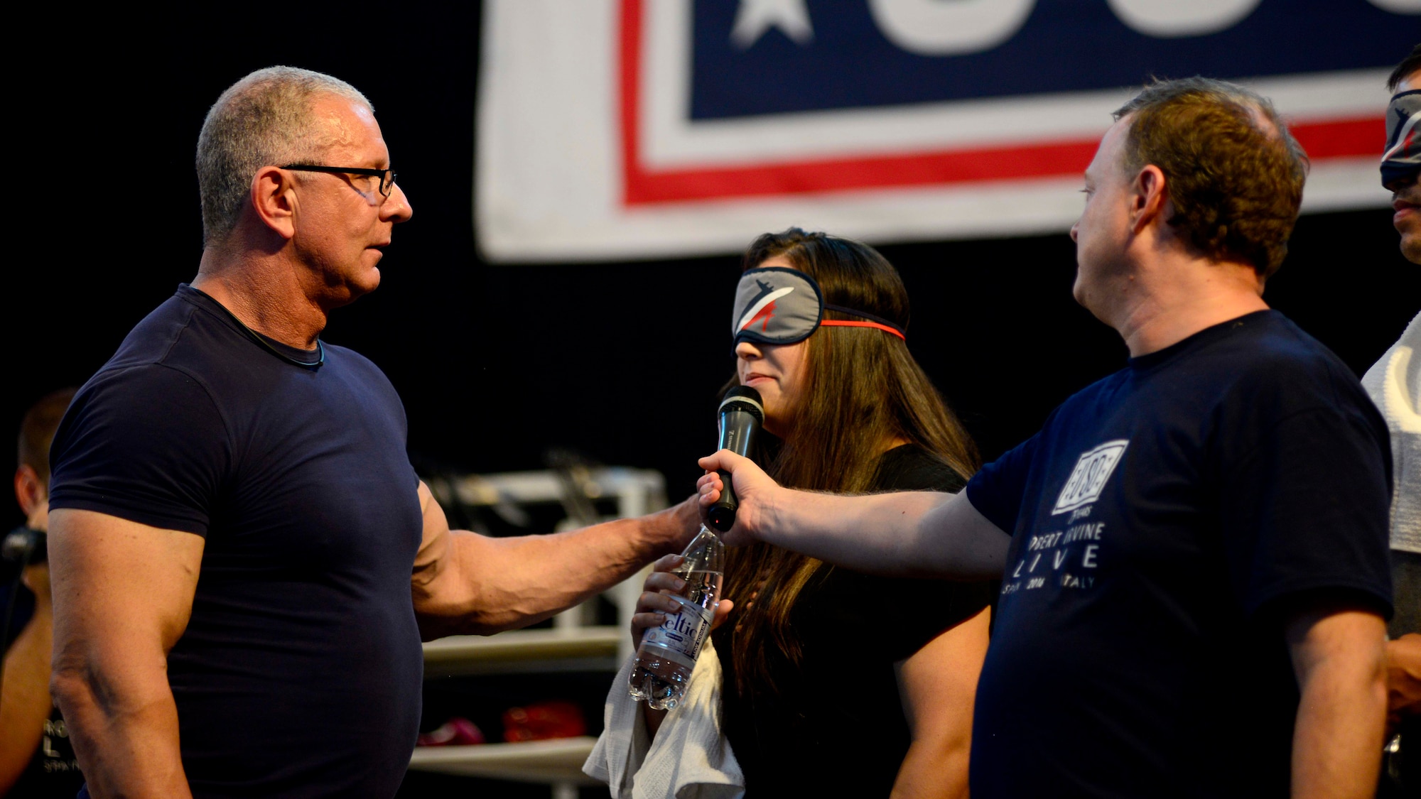 An audience member judges between culinary dishes, during the Robert Irvine Live USO Show, July 30, 2016 at Aviano Air Base, Italy. In addition to the event, Robert Irvine, celebrity chef, interacted with Airmen during a physical training session and lunch at the dining facility. (U.S. Air Force photo by Senior Airman Areca T. Bell/Released)