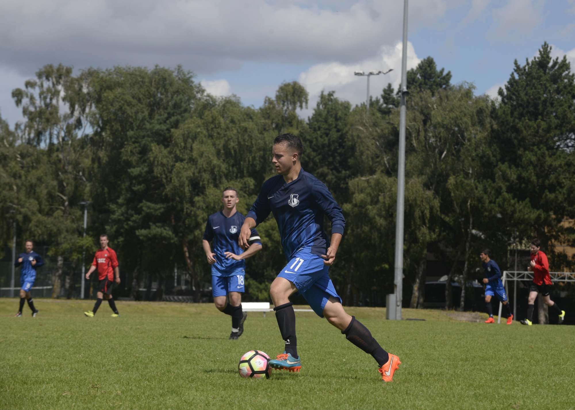 U.S. Air Force Senior Airman Christopher Sheeter, 48th Aircraft Maintenance Squadron standardization lead crew member, dribbles the ball toward the opposing team’s goal at Royal Air Force Lakenheath, England, July 31. The Liberty Football Club will compete in approximately 30 games this season against other teams in the surrounding area. (U.S. Air Force photo/Airman 1st Class Abby L. Finkel)