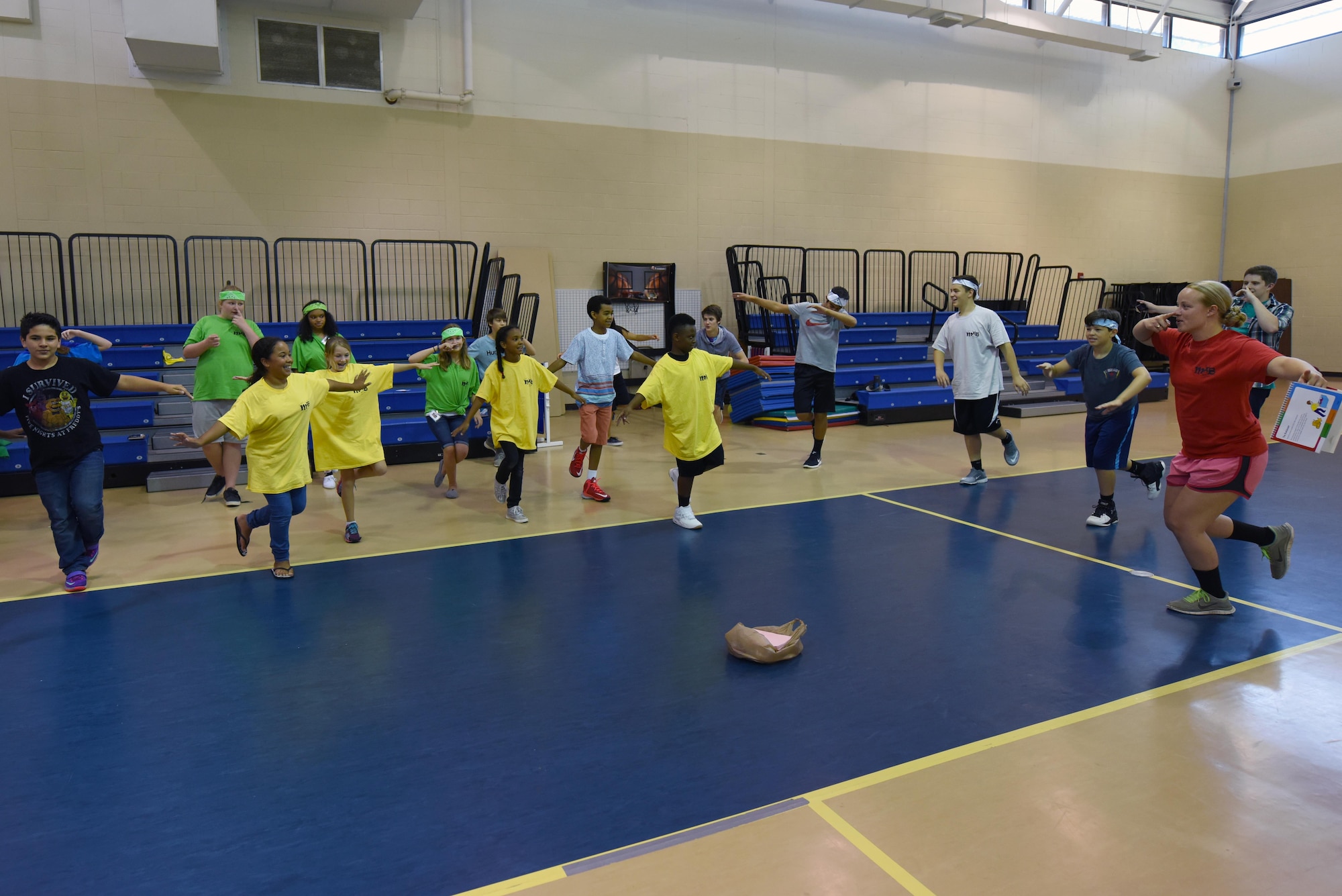 The Make It Better 4 Teens campers and instructors perform a warm-up exercise before exercising, July 26, 2016, at Seymour Johnson Air Force Base, North Carolina. Every day the MIB4T instructors and directors helped the students break the ice and have fun with a short interactive exercise, such as yoga, a game of rock, paper, scissors and trivia. (U.S. Air Force photo/Airman 1st Class Ashley Williamson)